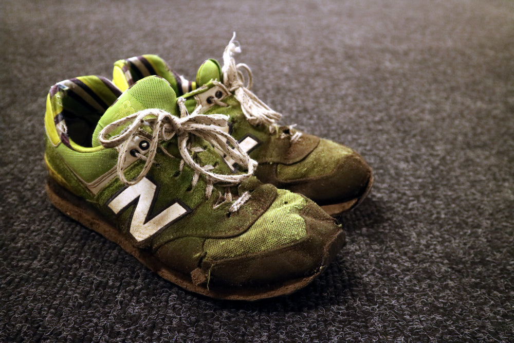 dirty green New Balance shoes
